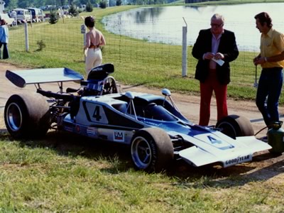 Warren Flickinger's Lola T300 waits in the paddock at Mid-Ohio in 1973. Copyright Terry Capps 2013. Used with permission.