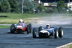 Stirling Moss in practice for the Warwick Farm '100' in his Lotus 21 ahead of John Youl in his Cooper Mk IV 'T51'.  Copyright John Ellacott 2008.  Used with permission.