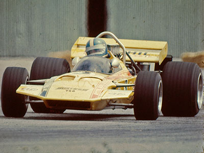 Mike Eyerly in the Bonphil Racing Surtees TS8 during the Tasman series in early 1971.  The Hangar doors in the background suggest this is at Wigram. Copyright Ted Walker 2012. Used with permission.