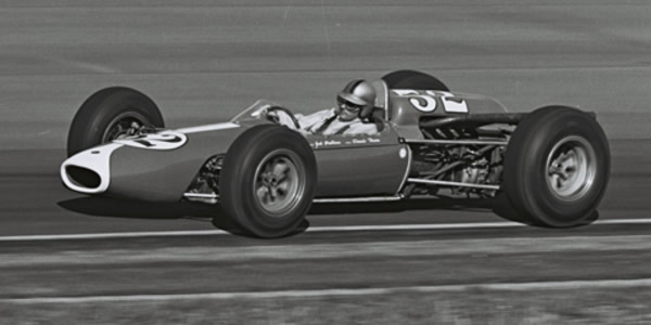Jack Brabham in the Brabham BT12 at Indy in 1964.  Part of the Dave Friedman collection. Licenced by The Henry Ford under Creative Commons licence Attribution-NonCommercial-NoDerivs 2.0 Generic. Original image has been cropped.