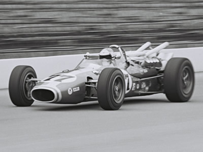Bruce Jacobi in George Walther's Dayton Steel Brake Gerhardt at the Indy 500 in 1967.  Part of the Dave Friedman collection. Licenced by The Henry Ford under Creative Commons licence Attribution-NonCommercial-NoDerivs 2.0 Generic. Original image has been cropped.
