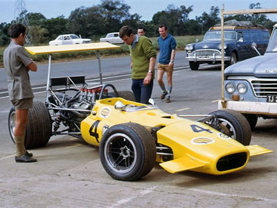 John McNicol's Lola T142 at Roy Hesketh, Pietermaritzburg Easter 1969 (John Mac is in the blue shirt and brown shorts behind the car). Copyright David Pearson 2007. Used with permission.