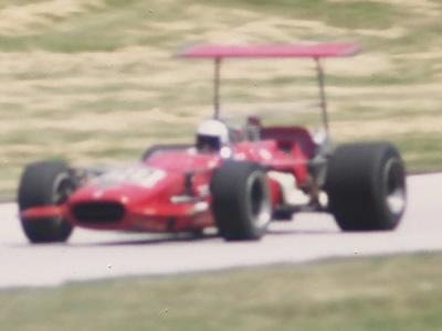 A fuzzy image of Jerry Geishart's T142 at the 1970 Road America June Sprints but enough to show us that it was red and that it was a T142.  Copyright Tom Schultz 2006.  Used with permission.