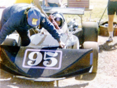 Wally Farrell's mechanic fits the nose of his Formula B March, at Phoenix in February 1977. Copyright John Blizzard 2020. Used with permission.