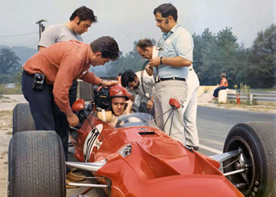 Scooter Patrick in Garner's TS5 at St Jovite in 1969.  Around the car are chief crew Max Kelly, Rob Fischetti and three of Garner's film crew. Copyright Rob Fischetti 2005. Used with permission.