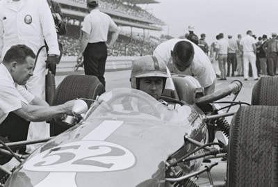 Jack Brabham awaits while the Zinc crew tend to the Brabham BT12 at Indy in 1964. Part of the Dave Friedman collection. Licenced by The Henry Ford under Creative Commons licence Attribution-NonCommercial-NoDerivs 2.0 Generic. Original image has been cropped. Jack Brabham awaits while the Zinc crew tend to the Brabham BT12 at Indy in 1964. Part of the Dave Friedman collection. Licenced by The Henry Ford under Creative Commons licence Attribution-NonCommercial-NoDerivs 2.0 Generic. Original image has been cropped.