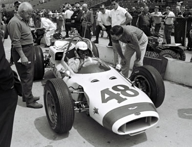 Pedro Rodriguez in the Cooper T54 in the pitlane at the Indy 500 in 1963. Part of the Dave Friedman collection. Licenced by The Henry Ford under Creative Commons licence Attribution-NonCommercial-NoDerivs 2.0 Generic. Original image has been cropped.