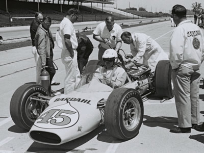 The 1964 Gerhardt in the pit lane during practice for the 1964 Indianapolis 500.  Part of the Dave Friedman collection. Licenced by The Henry Ford under Creative Commons licence Attribution-NonCommercial-NoDerivs 2.0 Generic. Original image has been cropped.