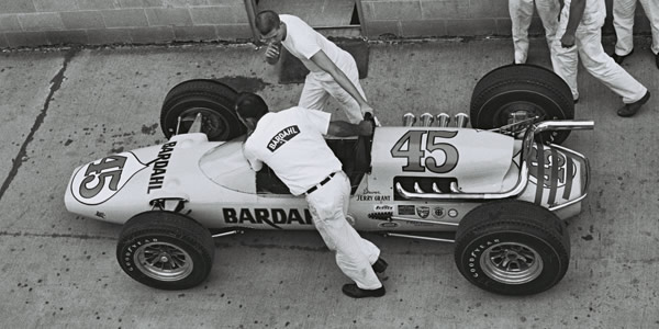 Jerry Grant's #45 Gerhardt is pushed to the track at Indianapolis in 1964 by Harry Salwasser (bottom) and a young Dennis Johansen (top). Part of the Dave Friedman collection. Licenced by The Henry Ford under Creative Commons licence Attribution-NonCommercial-NoDerivs 2.0 Generic. Original image has been cropped. Jerry Grant's #45 Gerhardt is pushed to the track at Indianapolis in 1964 by Harry Salwasser (bottom) and a young Dennis Johansen (top). Part of the Dave Friedman collection. Licenced by The Henry Ford under Creative Commons licence Attribution-NonCommercial-NoDerivs 2.0 Generic. Original image has been cropped.