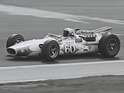 Mickey Shaw in Walt Michner's ex-Wilke #60 Gerhardt at the 1967 Indy 500.  Part of the Dave Friedman collection. Licenced by The Henry Ford under Creative Commons licence Attribution-NonCommercial-NoDerivs 2.0 Generic. Original image has been cropped.