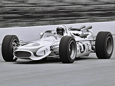 Mario Andretti in the 1967 Hawk II at the Indy 500 in 1967. Licenced by The Henry Ford under Creative Commons licence Attribution-NonCommercial-NoDerivs 2.0 Generic. Original image has been cropped.