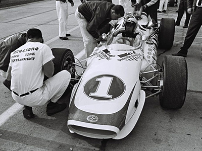 Mario Andretti in the 1967 Hawk II at the Indy 500 in 1967. Licenced by The Henry Ford under Creative Commons licence Attribution-NonCommercial-NoDerivs 2.0 Generic. Original image has been cropped.