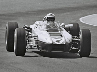 Bobby Unser in #7 Vita-Fresh Orange Juice Huffaker at the Indy 500 in 1966. Licenced by The Henry Ford under Creative Commons licence Attribution-NonCommercial-NoDerivs 2.0 Generic. Original image has been cropped.