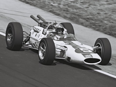Bud Tingelstad in Lindsey Hopkins' American Red Ball Lola T80 at the 1965 Indy 500.  Part of the Dave Friedman collection. Licenced by The Henry Ford under Creative Commons licence Attribution-NonCommercial-NoDerivs 2.0 Generic. Original image has been cropped.