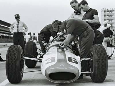 The Team Lotus #36 backup car at Indianapolis in 1964, showing off the significantly offset suspension. Part of the Dave Friedman collection. Licenced by The Henry Ford under Creative Commons licence Attribution-NonCommercial-NoDerivs 2.0 Generic. Original image has been cropped.