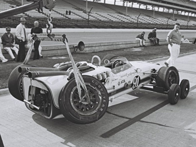 Mike Mosley had two accidents in 1966 Watsons during practice for the 1967 Indy 500, so it seems apt to illustrate this model hanging from a tow hook.  Part of the Dave Friedman collection. Licenced by The Henry Ford under Creative Commons licence Attribution-NonCommercial-NoDerivs 2.0 Generic. Original image has been cropped.