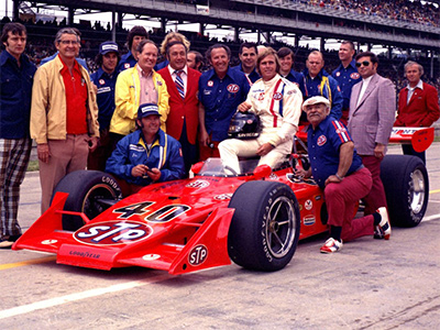 Swede Savage poses with his Eagle 72 alongside Andy Granatelli, George Bignotti and crew at the 1973 Indy 500.  Copyright Indianapolis Motor Speedway. Copyright permissions granted for non-commercial use by Indianapolis Motor Speedway.