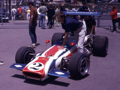 John Cannon's Hogan-Starr Racing McLaren M10B is pushed through the Laguna Seca paddock in June in 1970. Copyright Mark Manroe 2006. Used with permission.