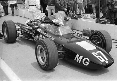 The #67 MG Liquid Suspension Huffaker in the pitlane at the Indy 500 in 1966. Copyright Allen Brown (slide acquired on eBay) 2026. Used with permission.
