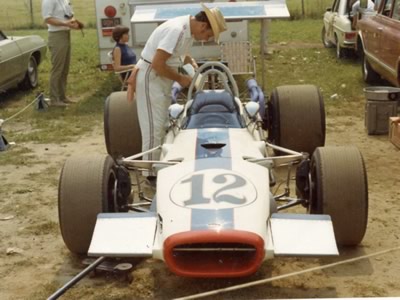Bill 'Murph' Mayberry tending to George Wintersteen's Lola T142 at Lime Rock Park 1969. Copyright Greg Rickes 2012. Used with permission.