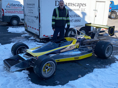 James Paterek with his Lola T240 in less-than-ideal weather conditions for racing. Copyright John Paterek 2022. Used with permission.