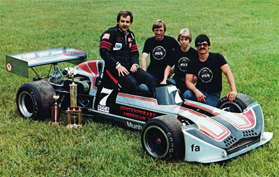 Roger Riekenberg and the March 73B and his crew in 1980: main mechanic Bill Munholland, his son Bill Jr, and second mechanic Jim Jacques. Copyright Roger Riekenberg 2020. Used with permission. Roger Riekenberg and the March 73B and his crew in 1980: main mechanic Bill Munholland, his son Bill Jr, and second mechanic Jim Jacques. Copyright Roger Riekenberg 2020. Used with permission.