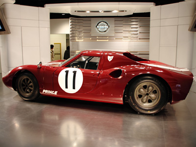 One of the Prince R380s at a Nissan showroom in January 2011. Licenced by MIKI Yoshihito under Creative Commons licence Attribution 2.0 Generic (CC BY 2.0 DEED). Original image has been cropped. One of the Prince R380s at a Nissan showroom in January 2011. Licenced by MIKI Yoshihito under Creative Commons licence Attribution 2.0 Generic (CC BY 2.0 DEED). Original image has been cropped.